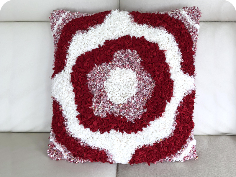 Rag Rug Cushion design with flower in red and white fabric 