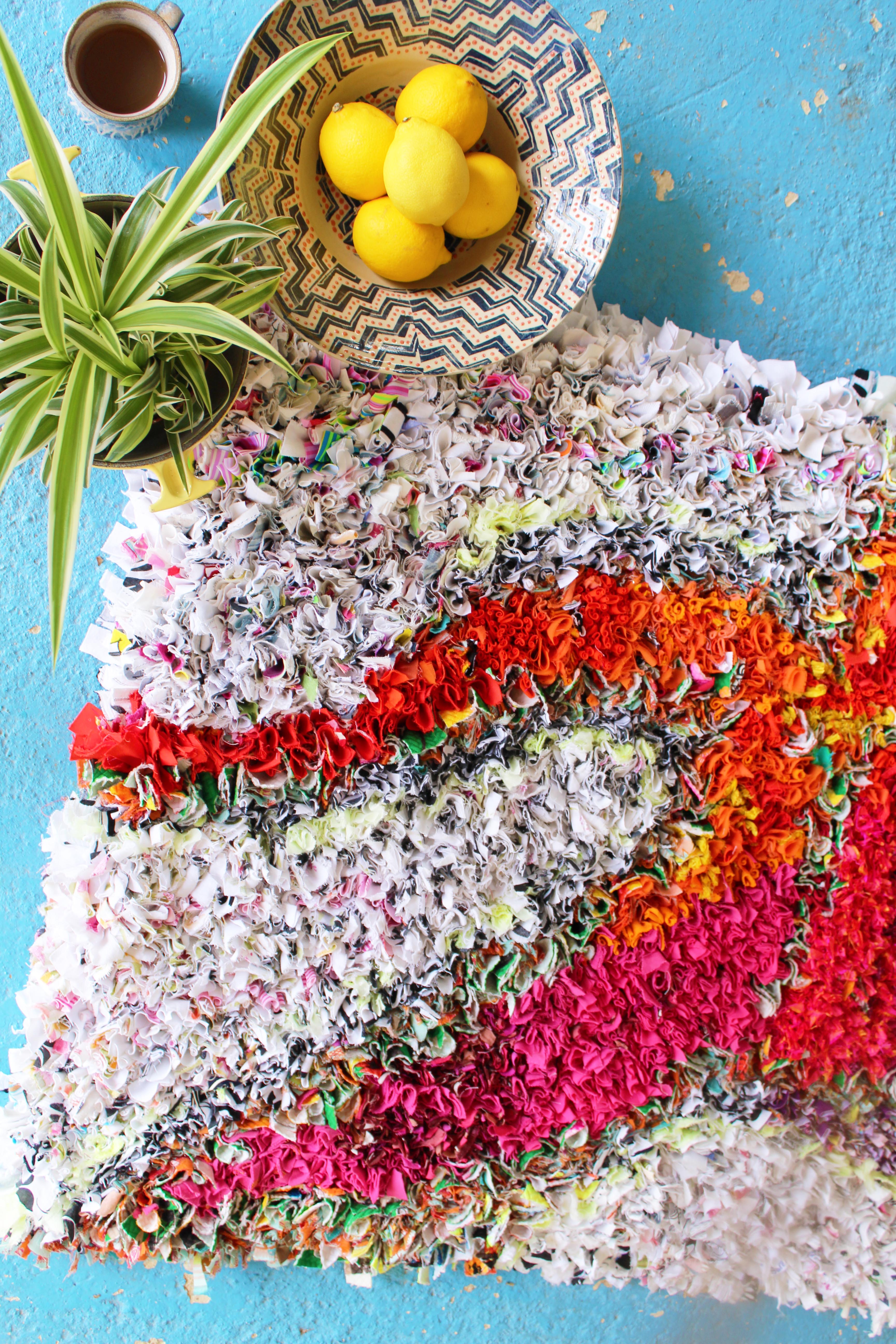 Styling a rag rug with lemons, a plant, a bowl and a mug