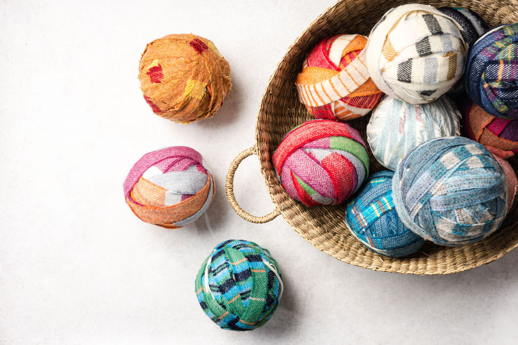 Balls of multicoloured and plaid blanket yarn for craft