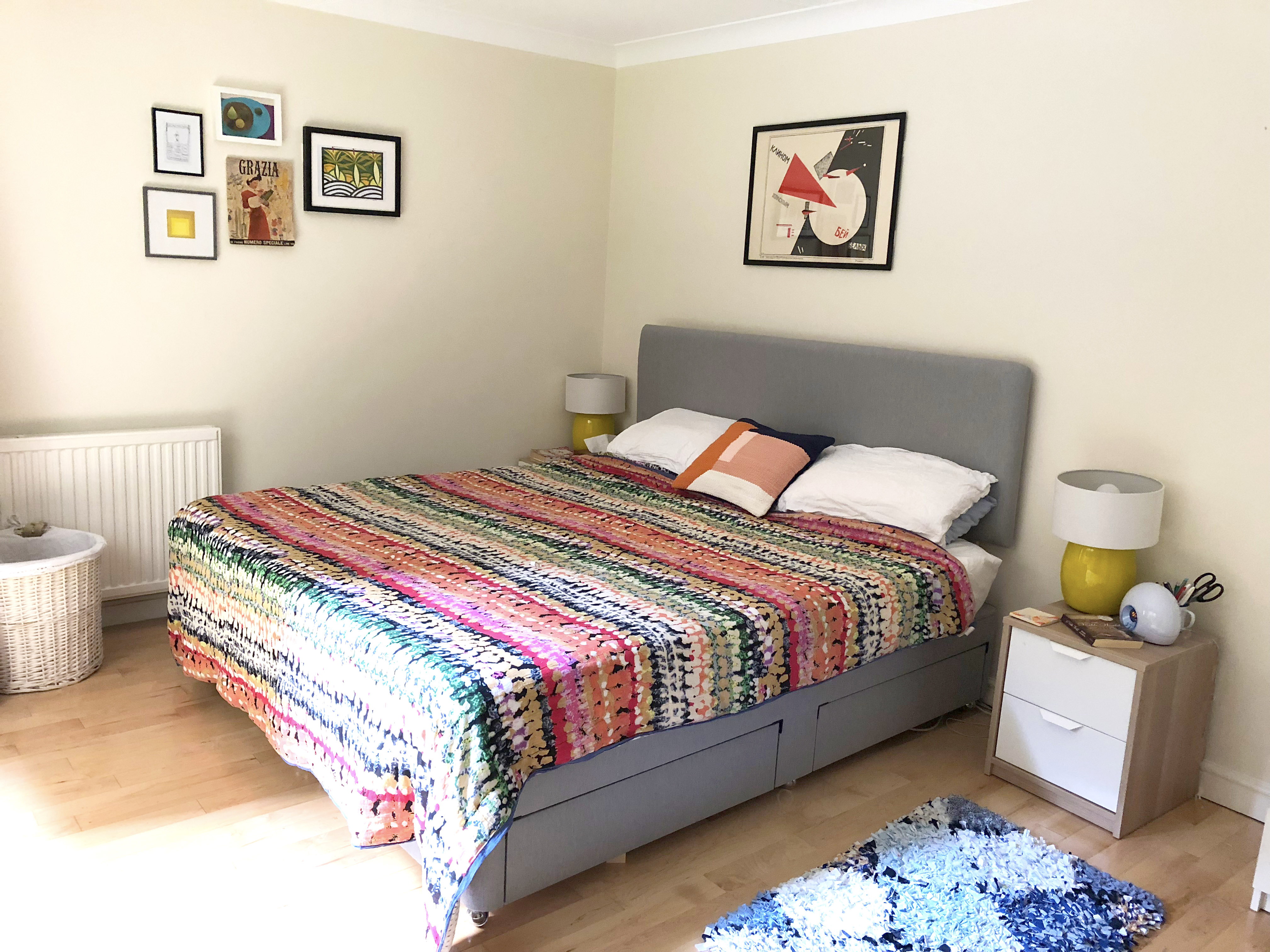 Brightly coloured bedroom in new Wapping flat with colourful Anthropologie bedspread