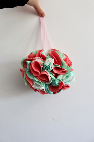 pink and green party pom pom hanging