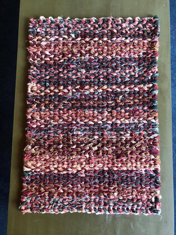 mixed pinks and purples twined rag rug
