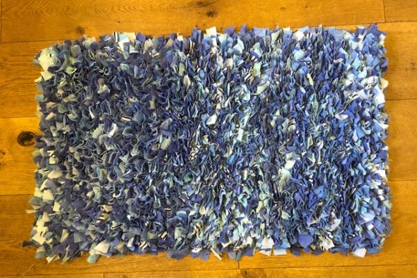 Blue shaggy rag rug on floor