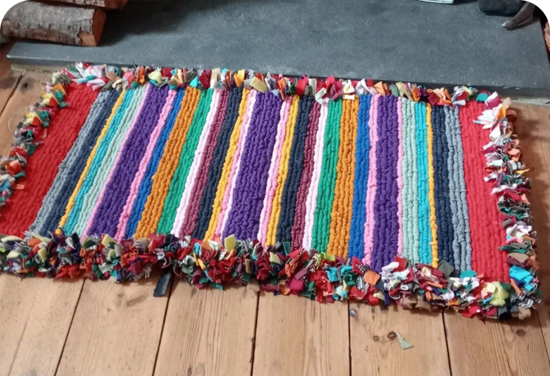 Colourful locker hooked rag rug made by student Jane using t-shirt material and jersey