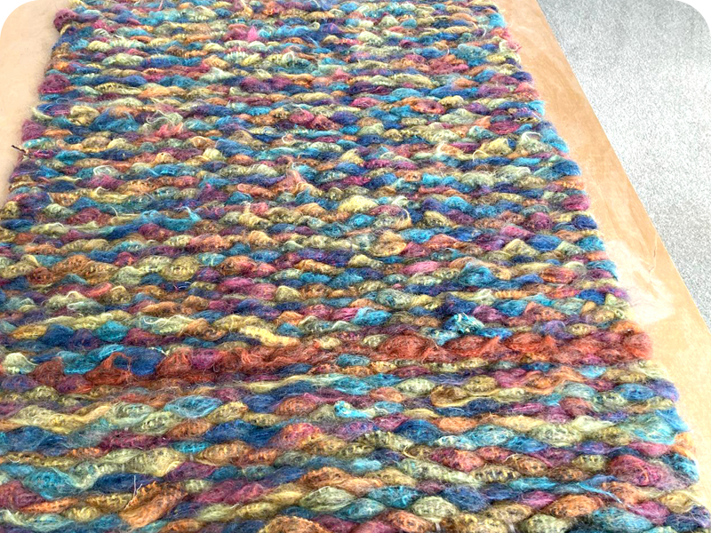 Multicoloured woollen peg loom woven rug