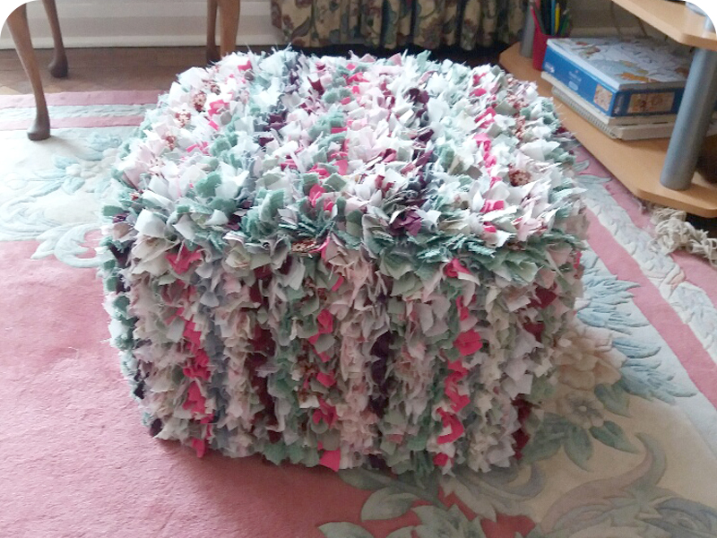 pink and green rag rug pouffe with stripes