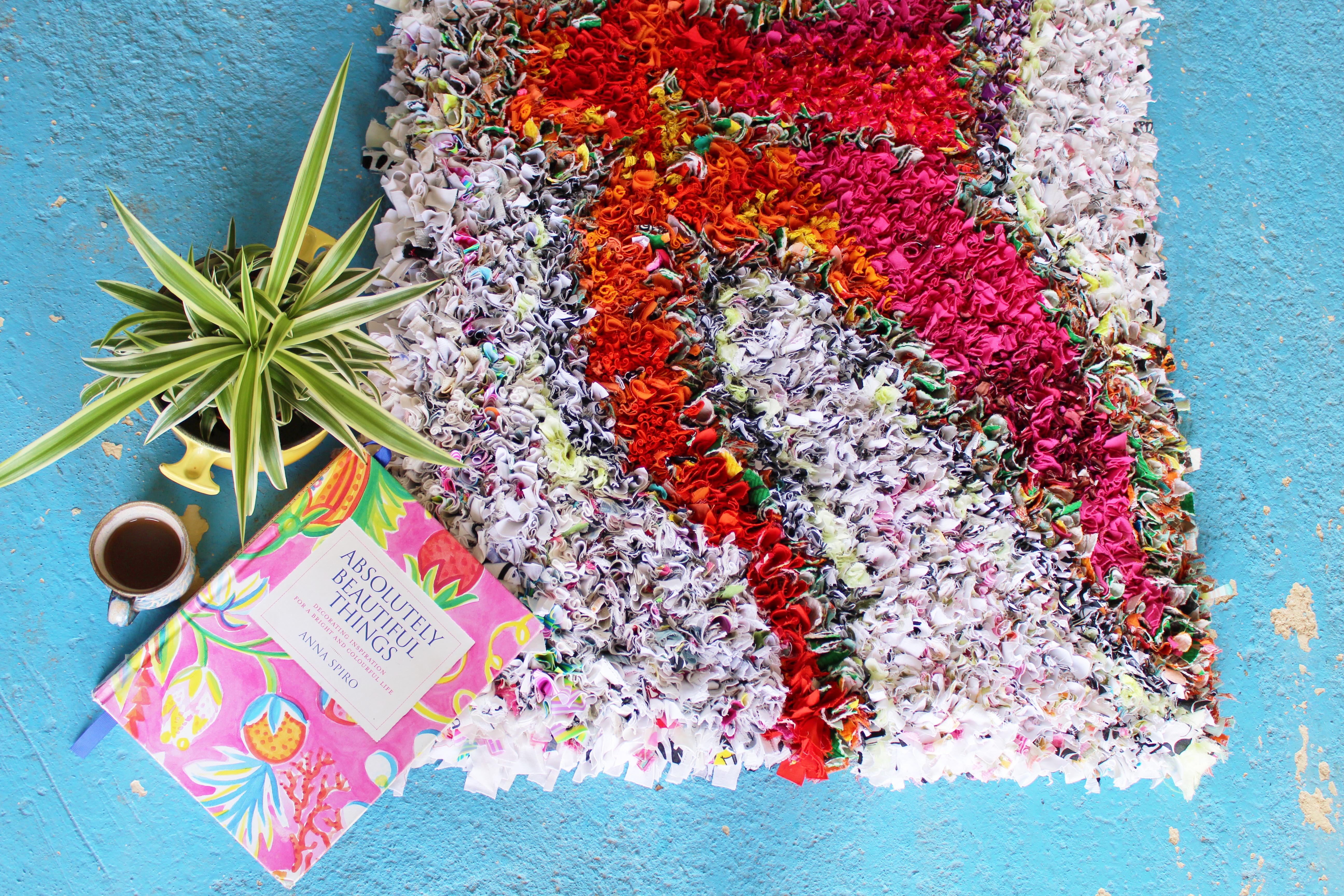 Absolutely Beautiful Things Book by Anna Spiro on top of a Rag Rug with a Palm and coffee