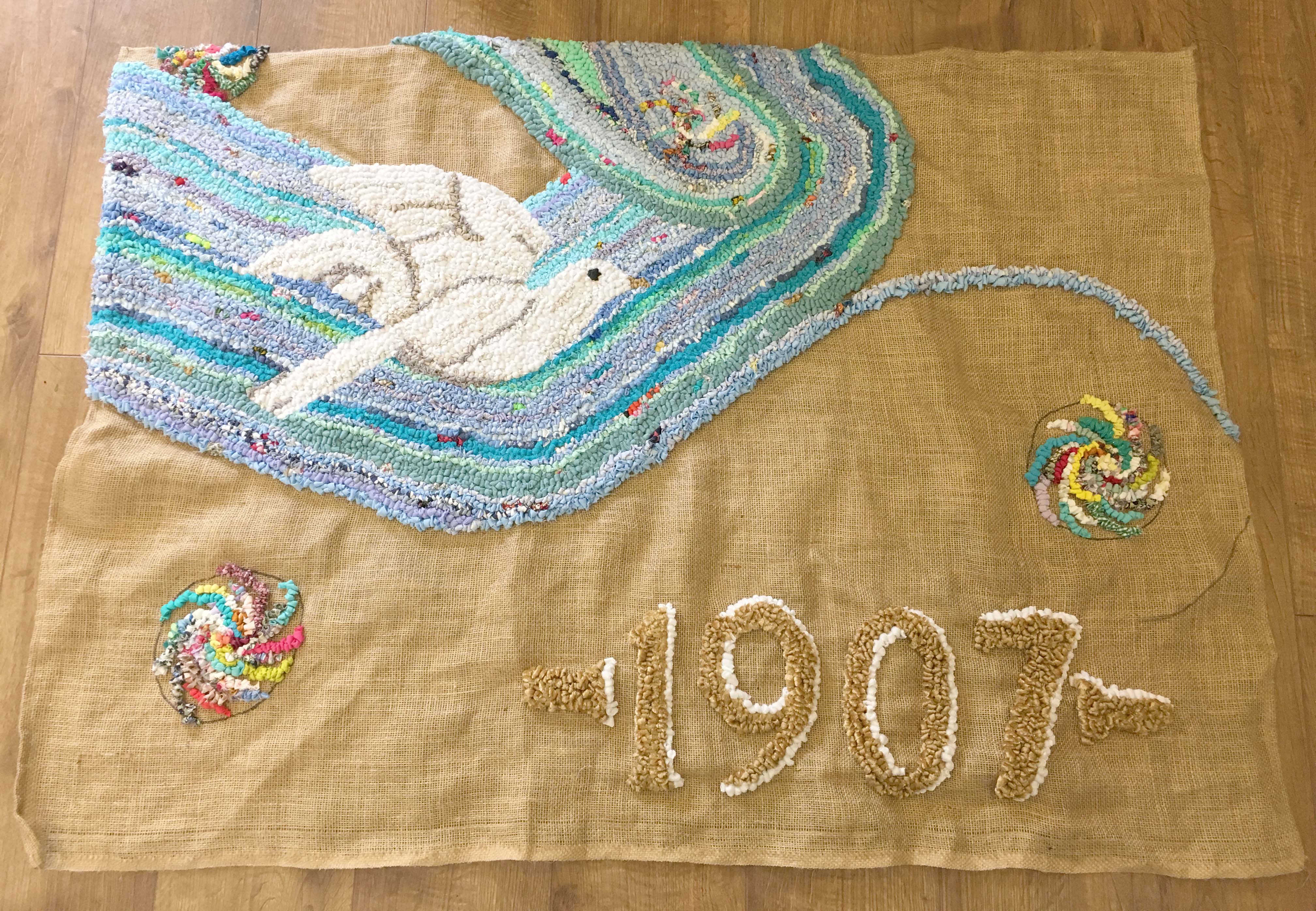 Creating a piece of rag rug art using old clothing and fabric offcuts