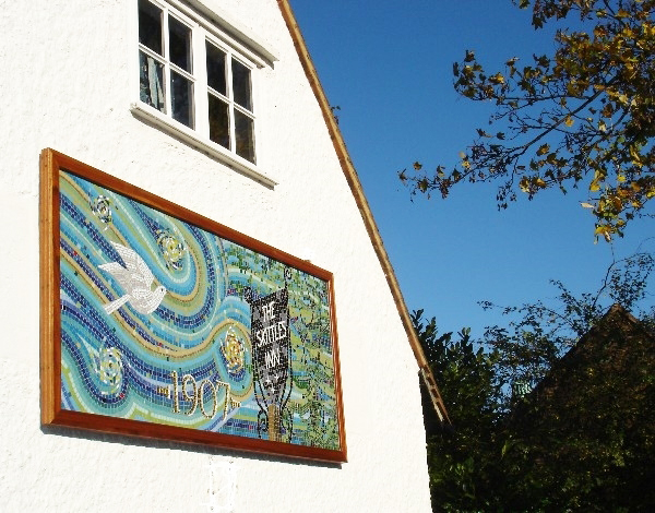 The Bird and Sky Mosaic on the side wall of the Settlement in Letchworth Garden City