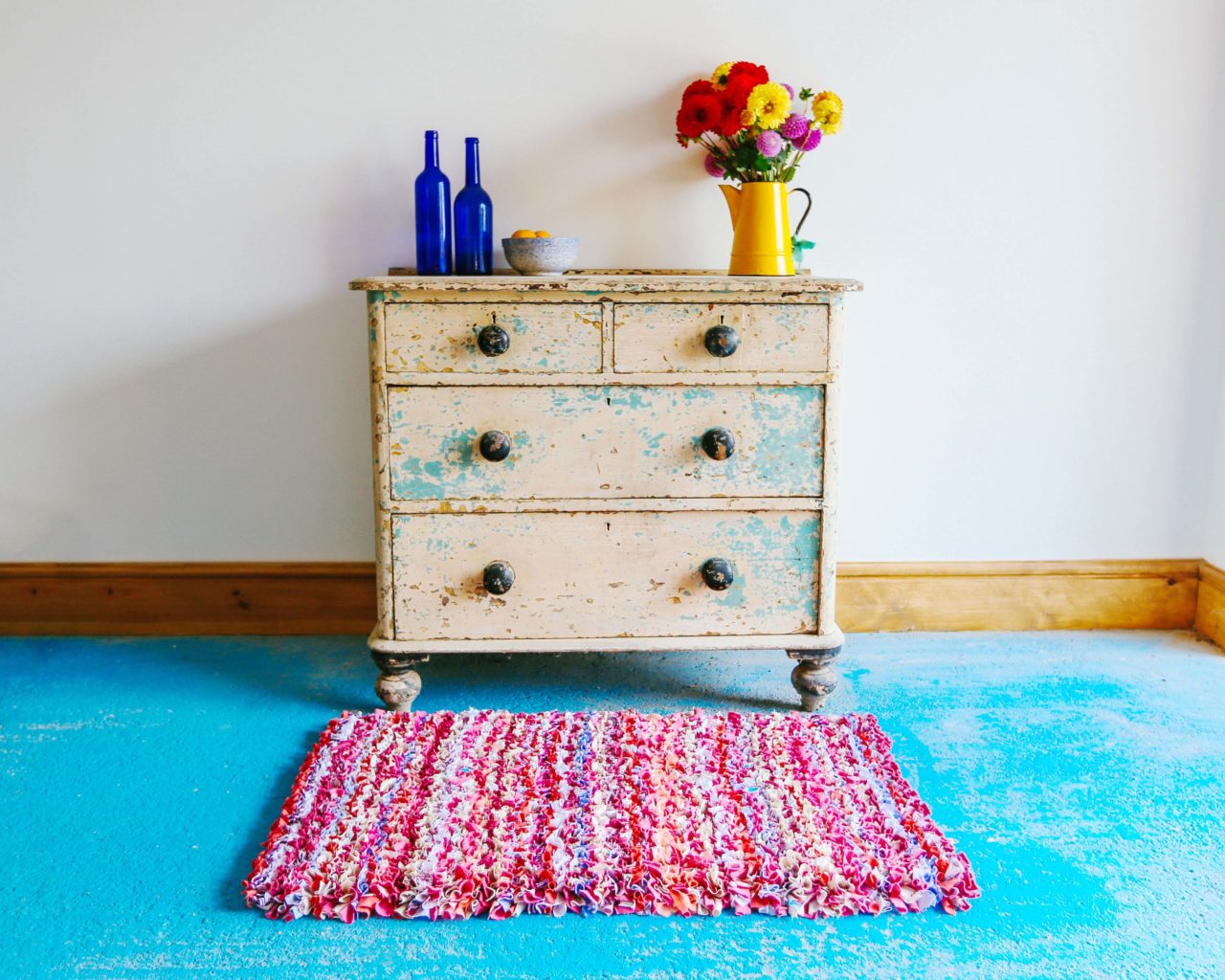 Ragged Life Pink Striped Rag Rug in front of chest of drawers