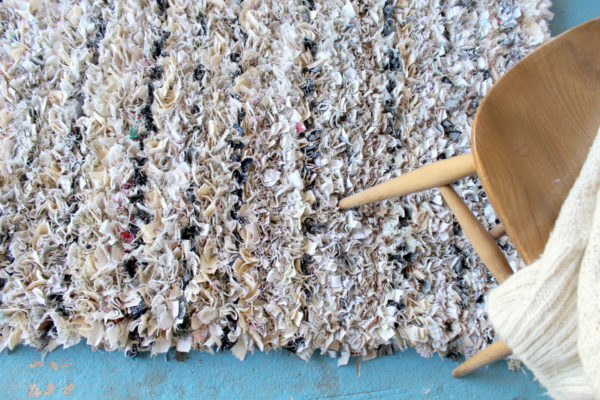 cream shaggy rag rug on floor with chair on top made out of old sheets
