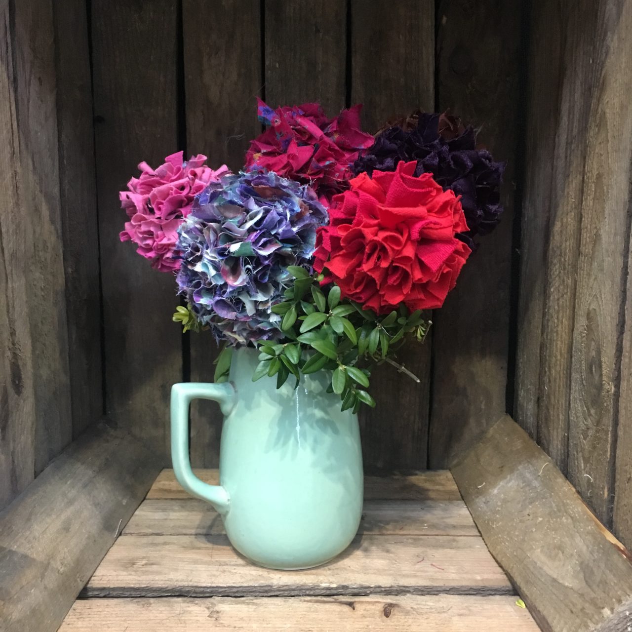 Rag Rug Bunch of Flowers in a jug on display