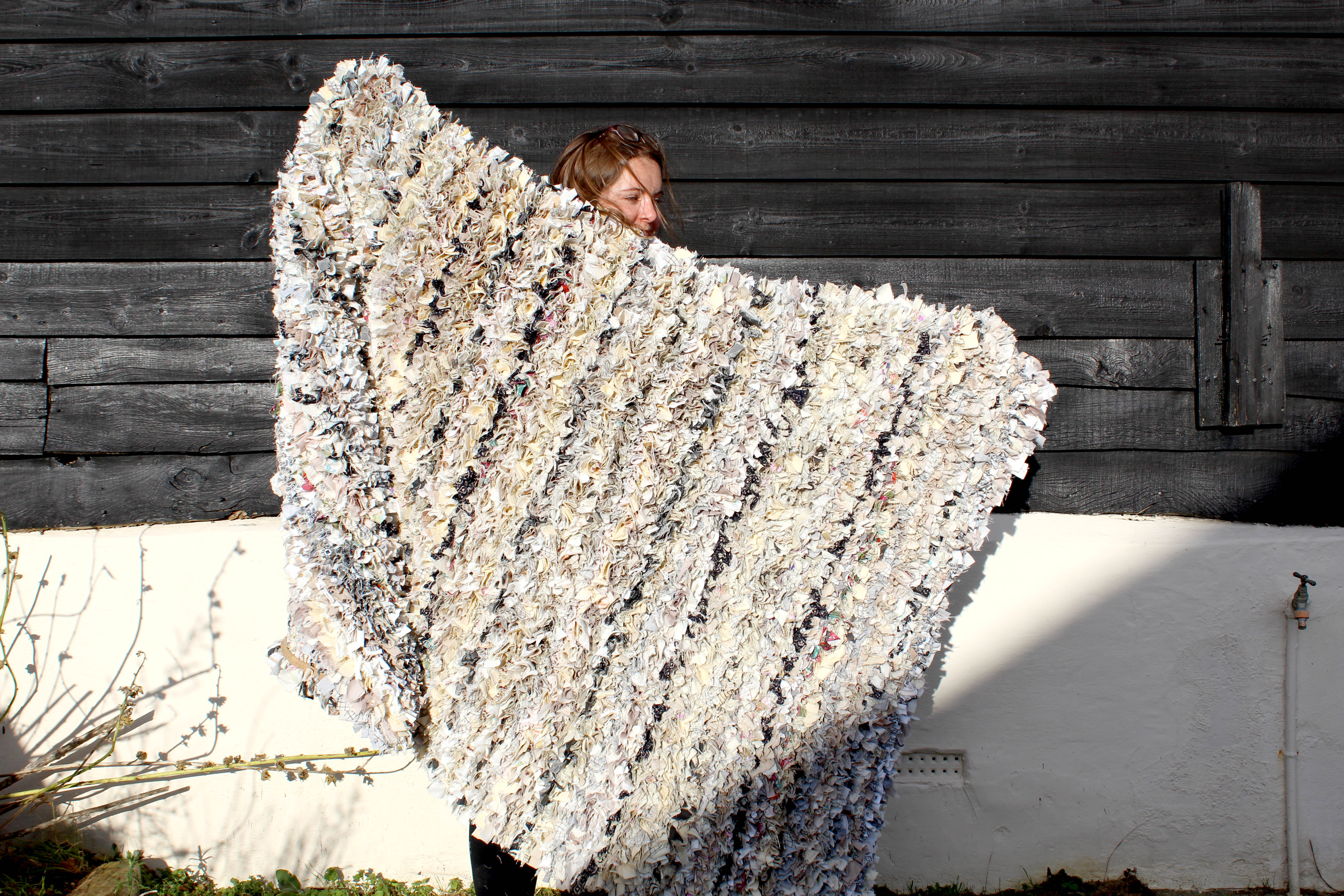 200 x 140cm extra large rag rug made using cream and grey assorted fabrics held up