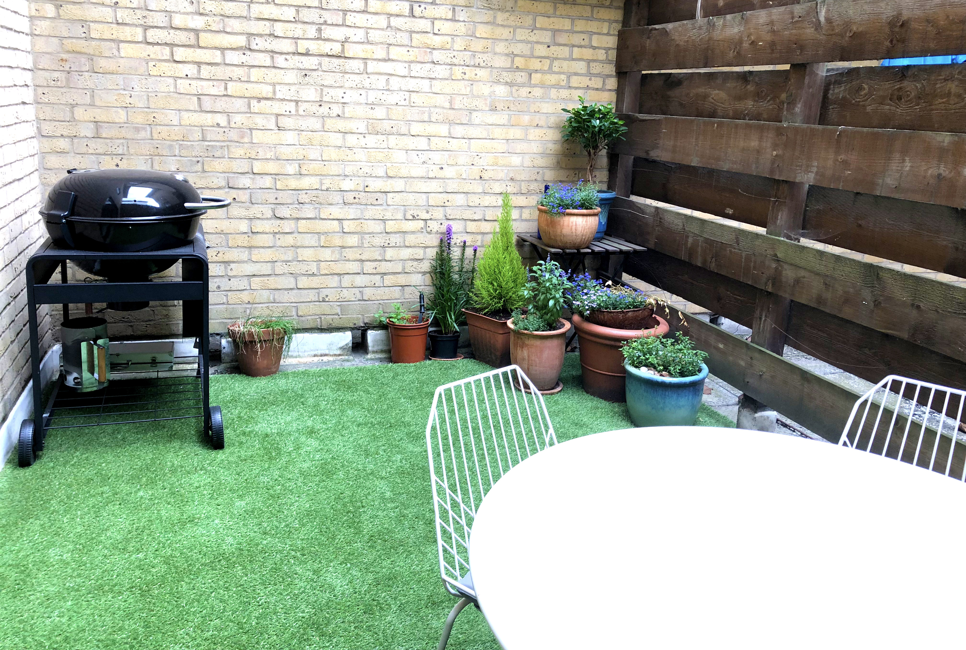 Small London garden with artificial grass plants