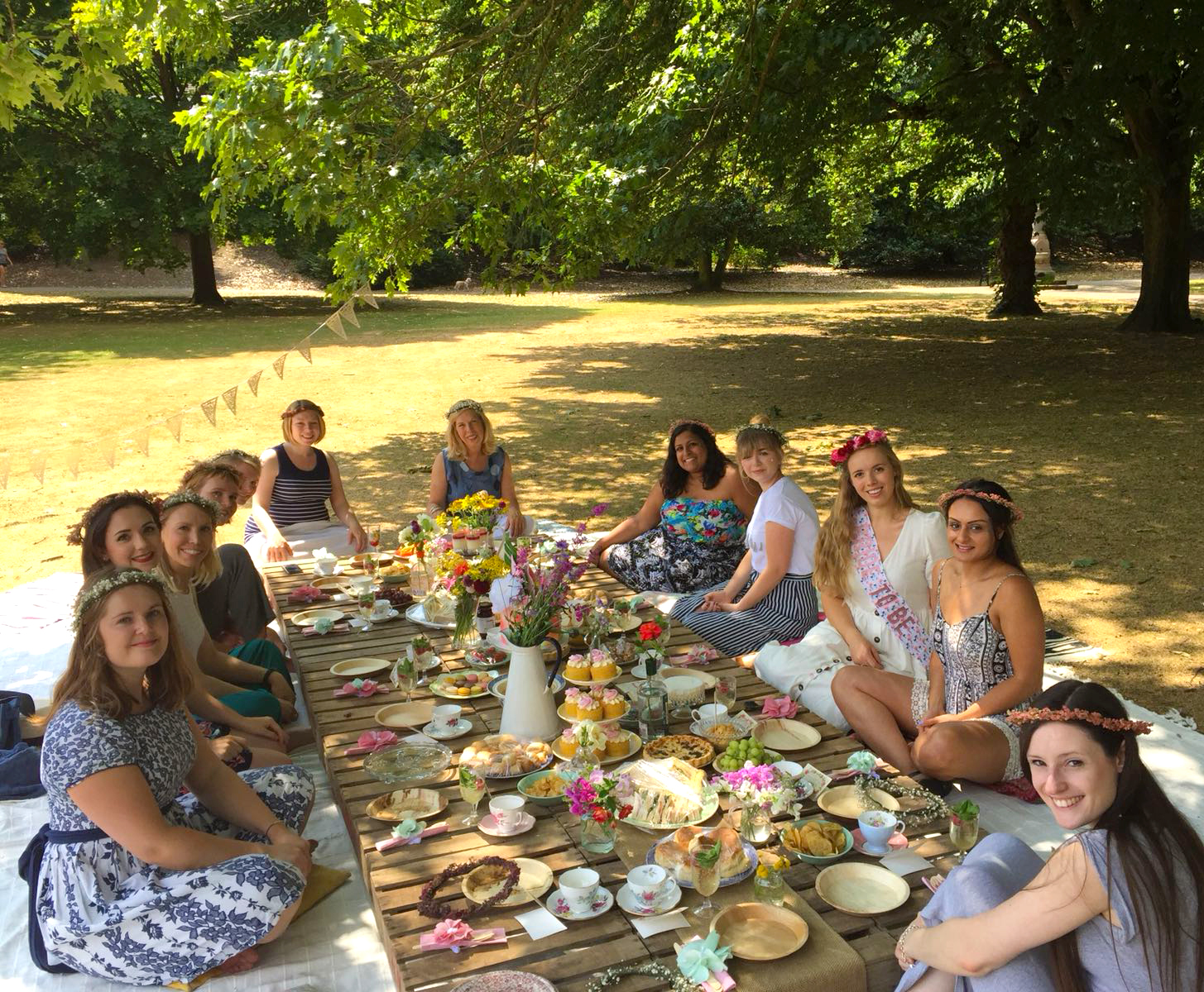 Fun hen do picnic in the park with flowers and crates etc...