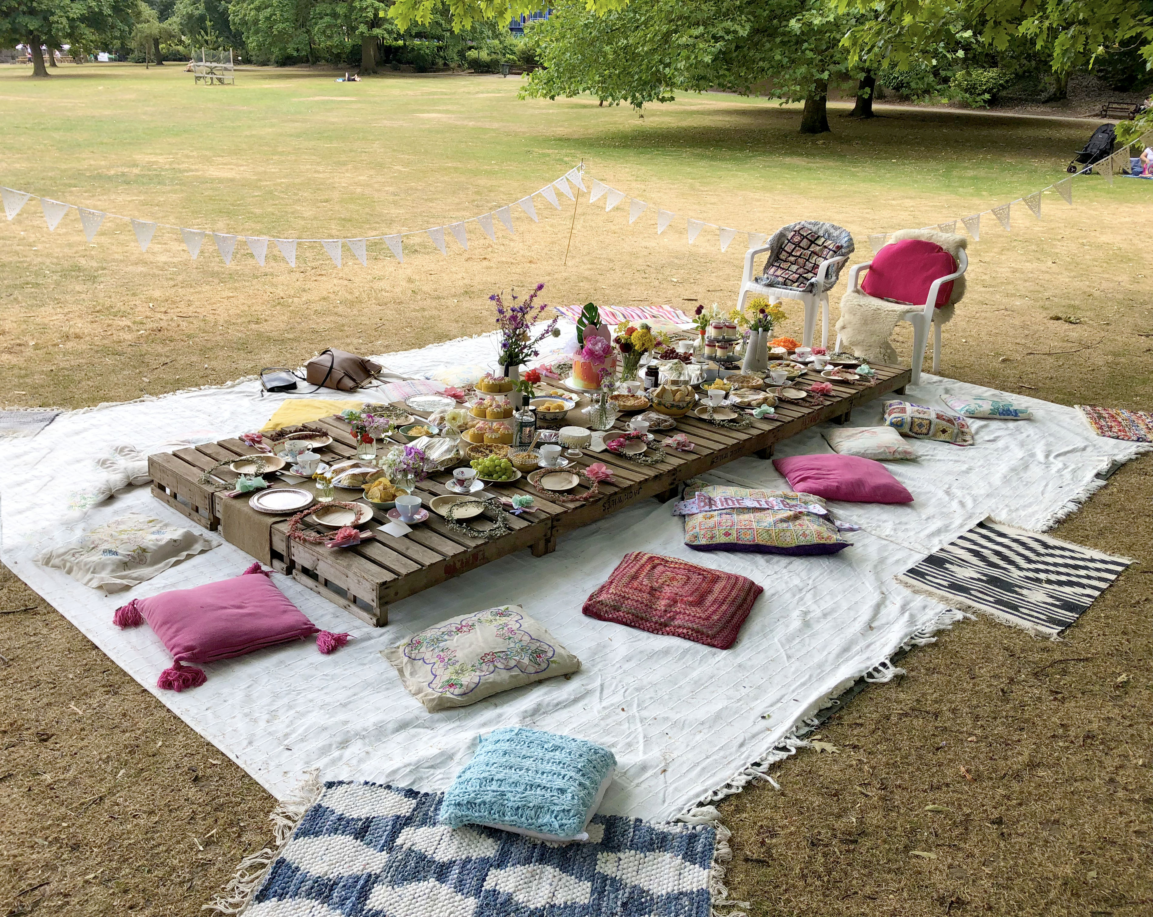 Chilled and colourful hen do in the park bohemian decorations and picnic