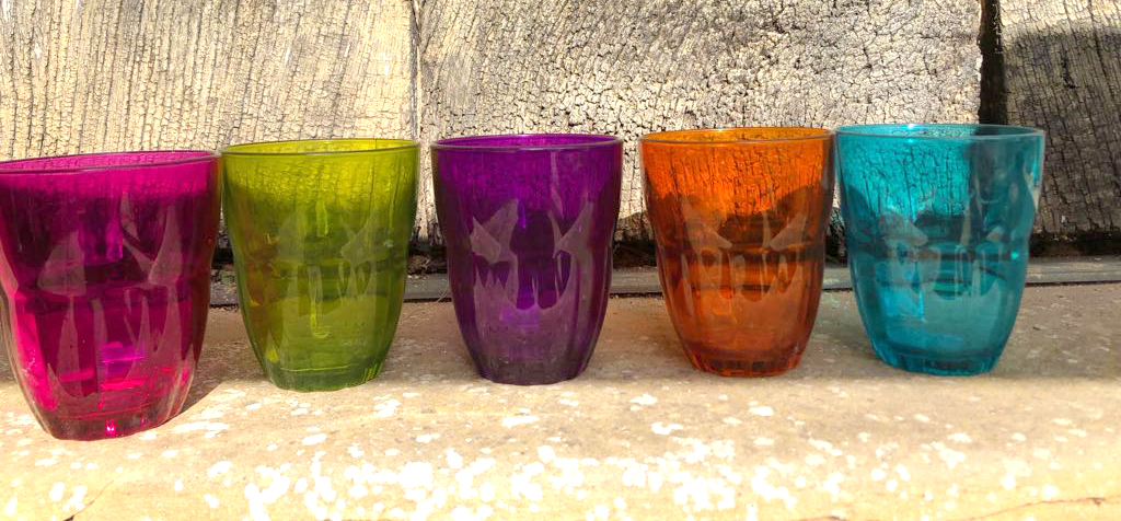 Colourful water glasses in a row