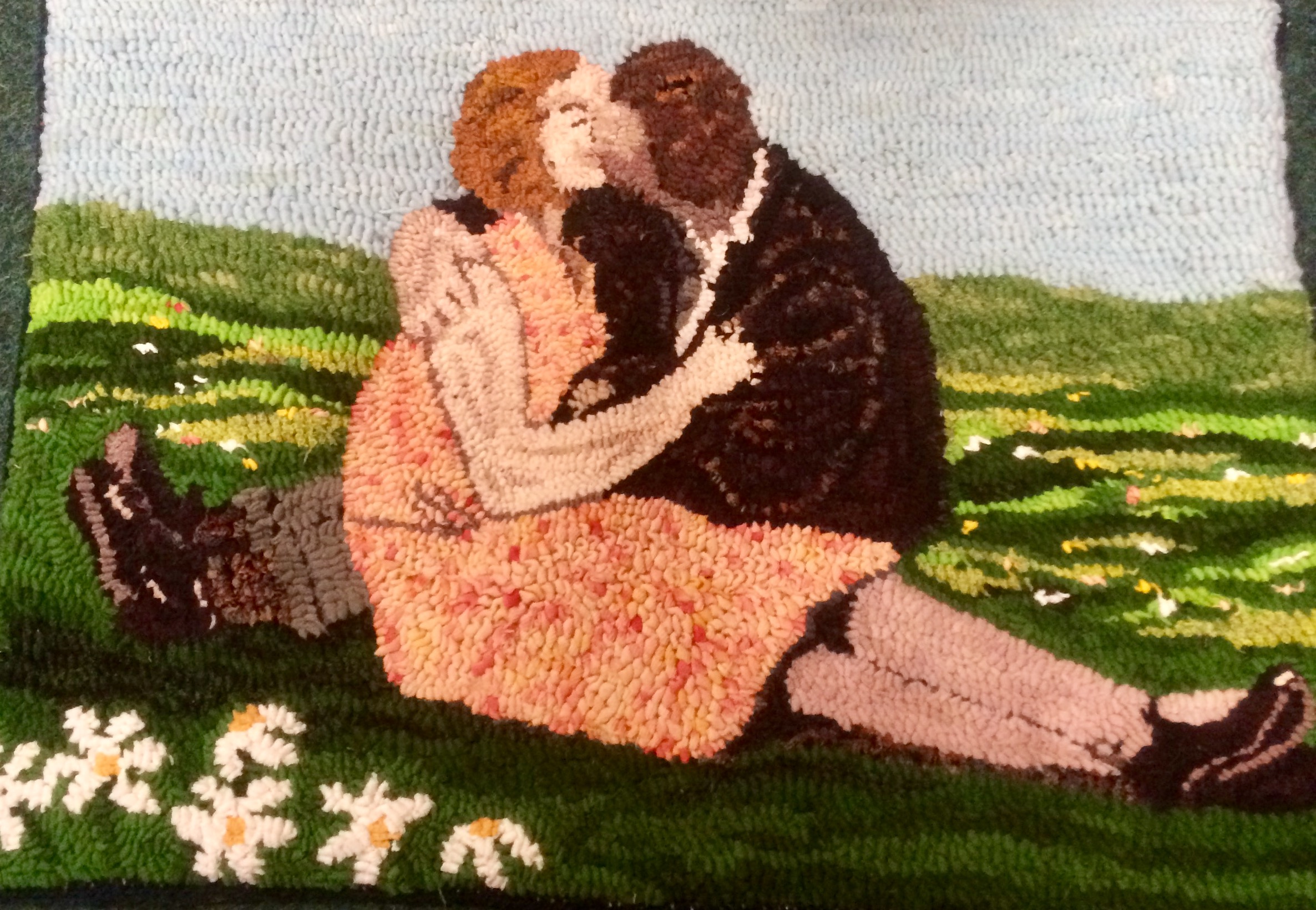 Rag Rug artwork in the loopy technique of a woman and man kissing