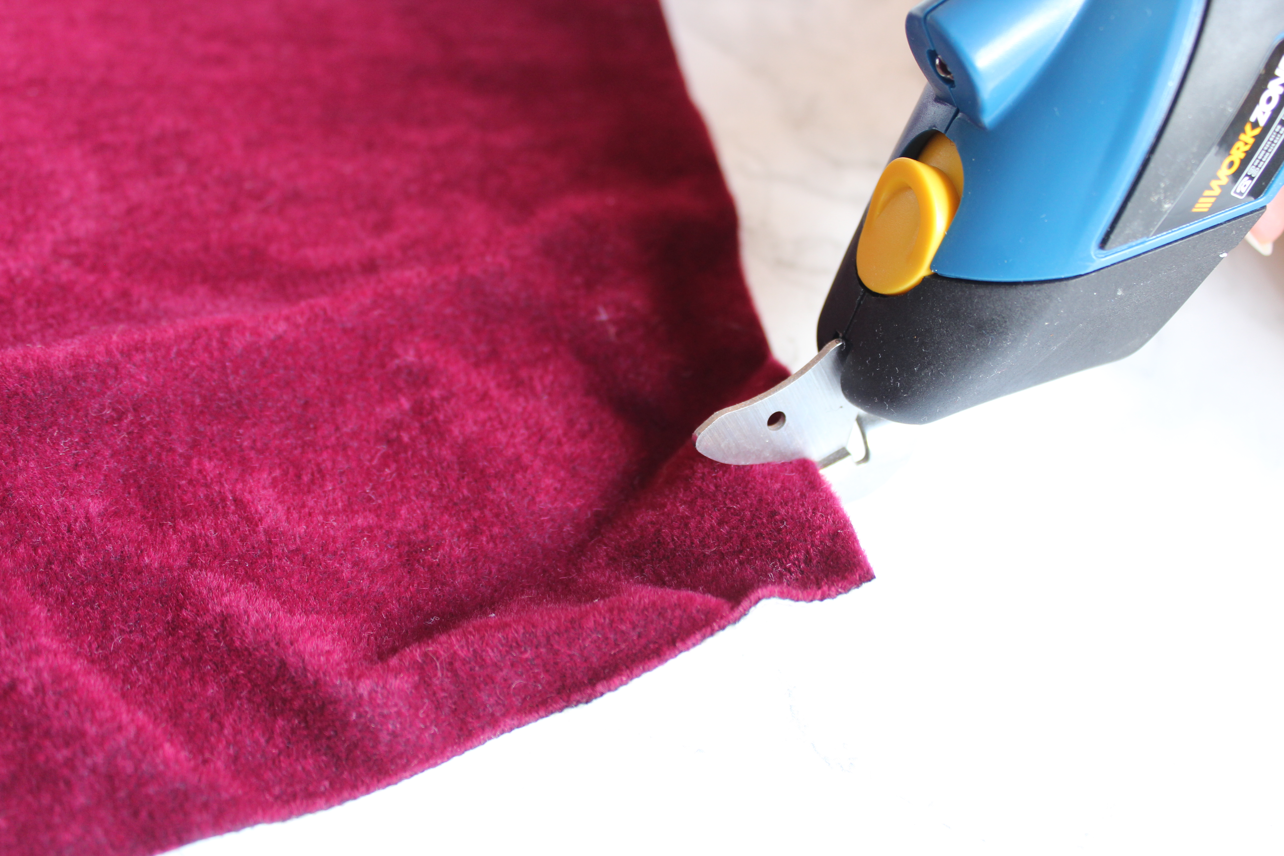 Cutting thick red curtain fabric with the Aldi Workzone Cordless Cutter