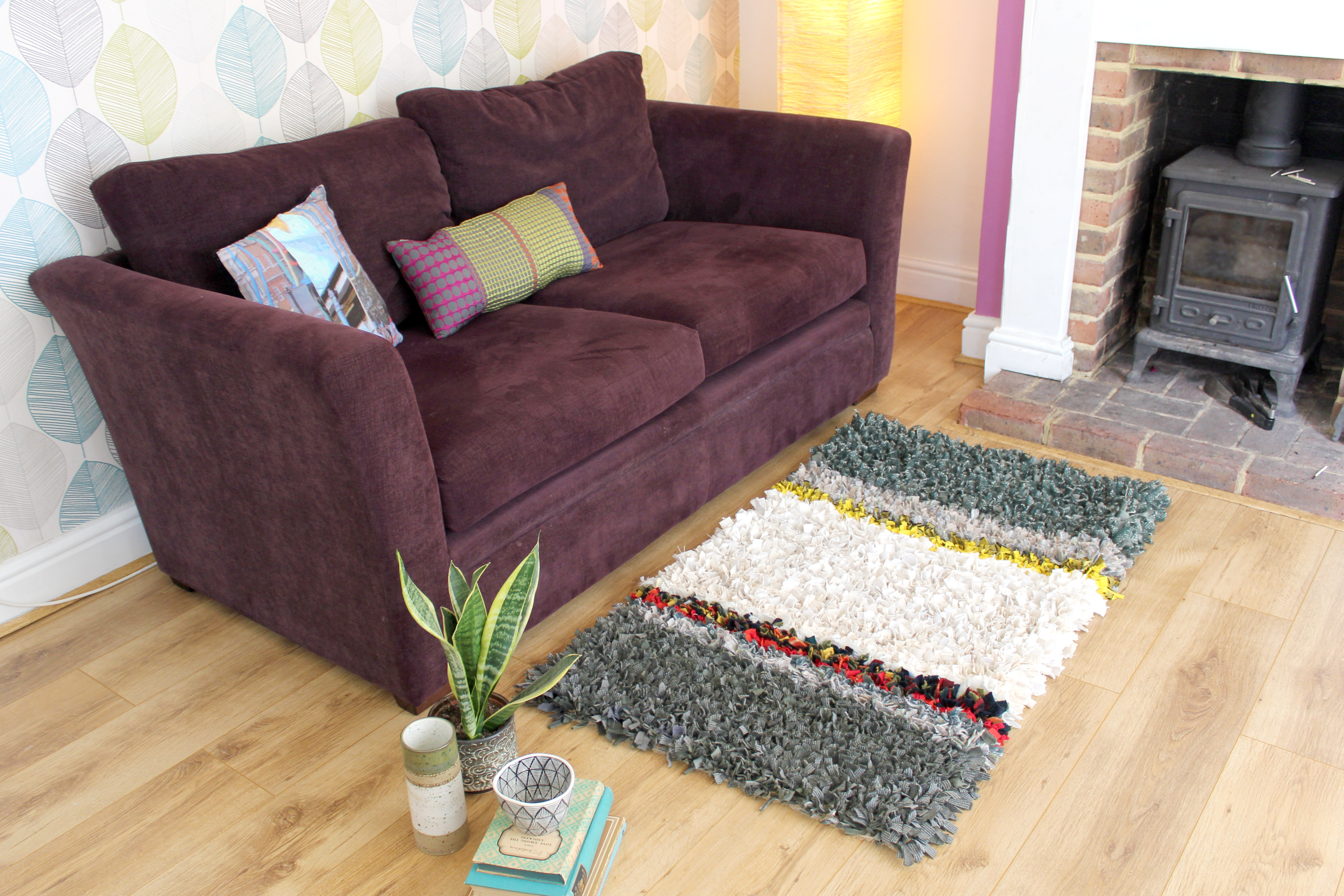 Cosy shaggy rag rug in front of sofa in living room made out of woollen material