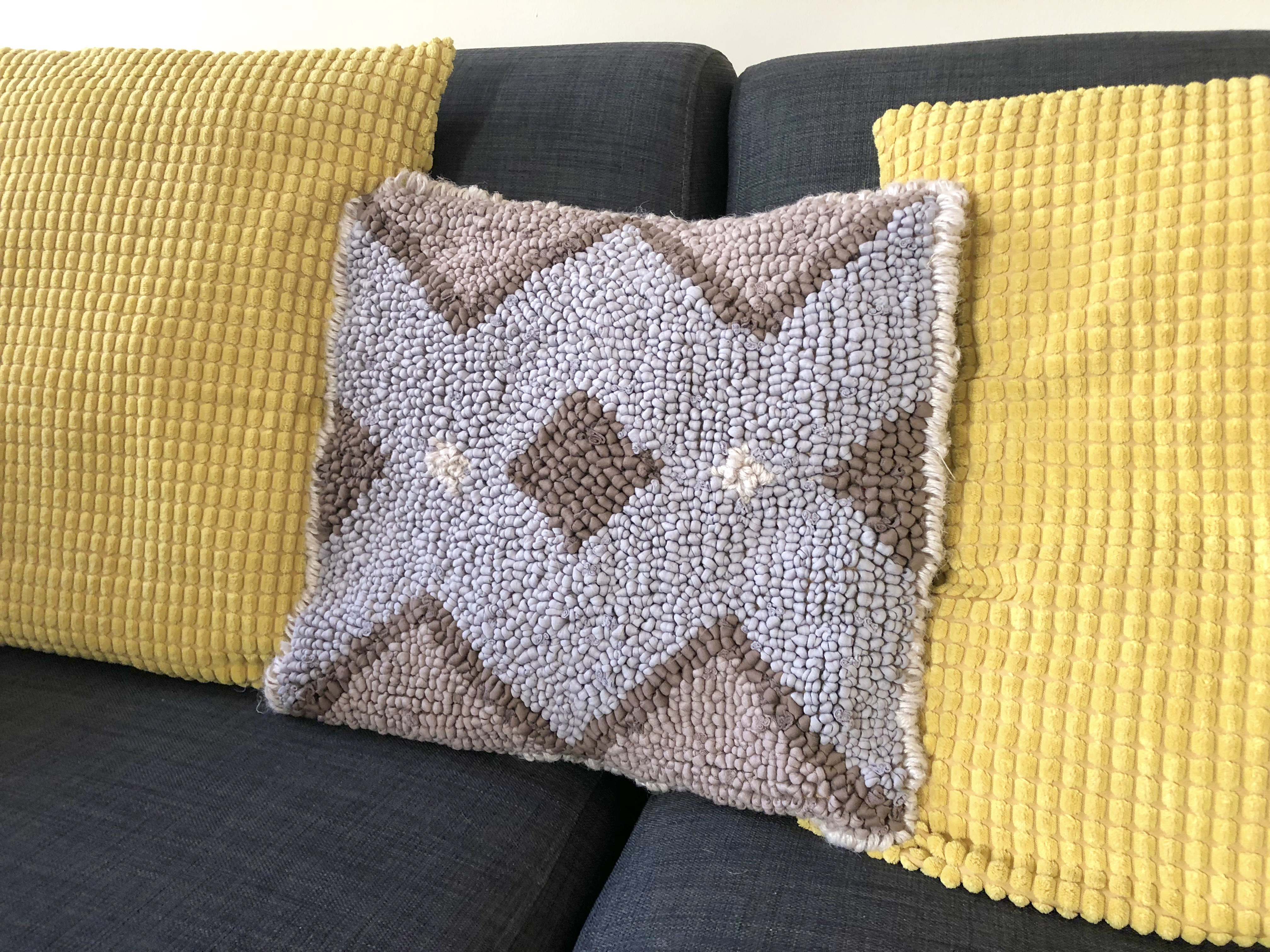Rag Rugging with t-shirt yarn. Grey and brown loopy rag rug cushion in a geometric design made using Hoooked t-shirt yarn