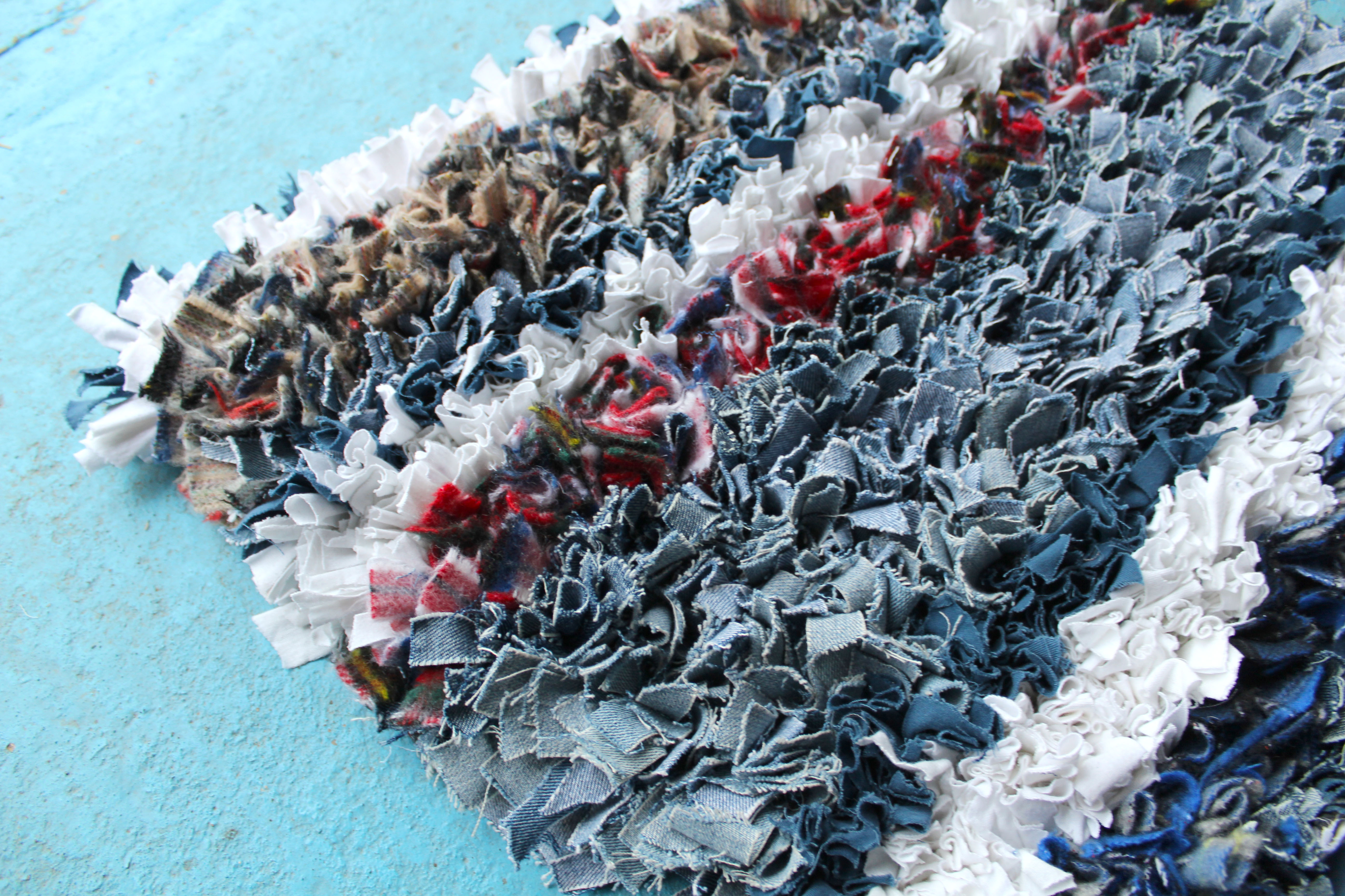 Denim, tartan and white rag rug in stripes made of old jeans
