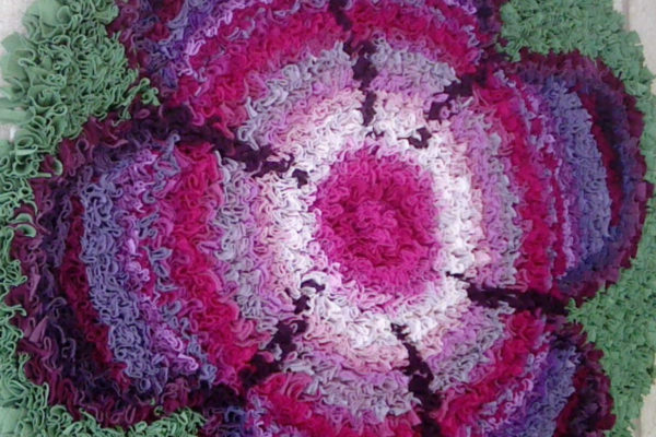 Stephanie Gaston flower rag rug in pink with green background