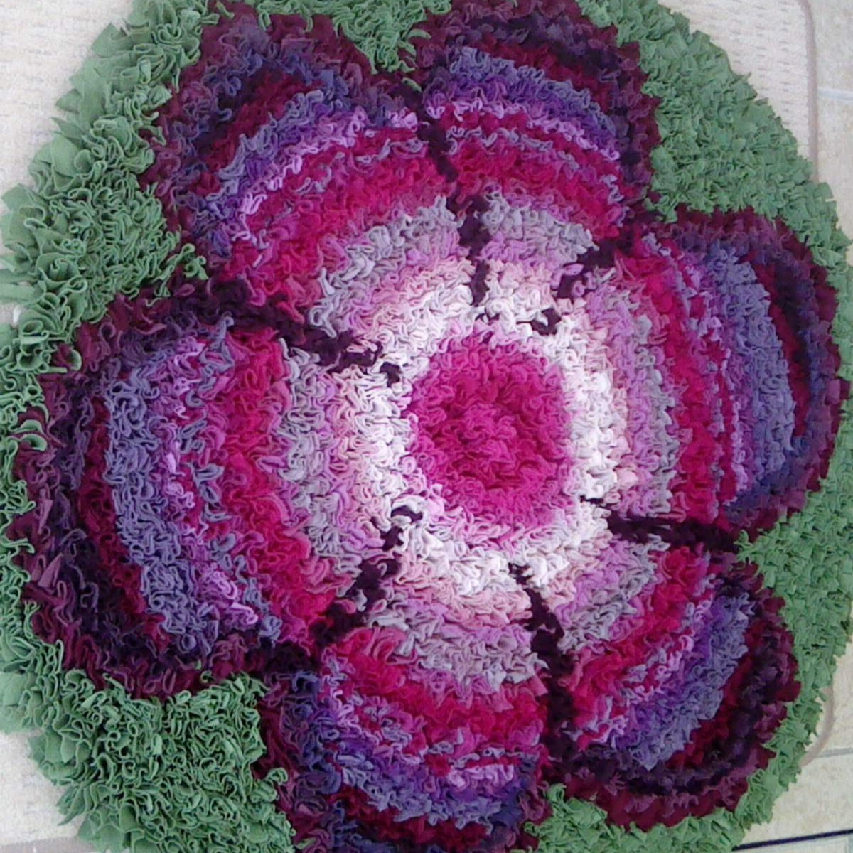 Stephanie Gaston flower rag rug in pink with green background