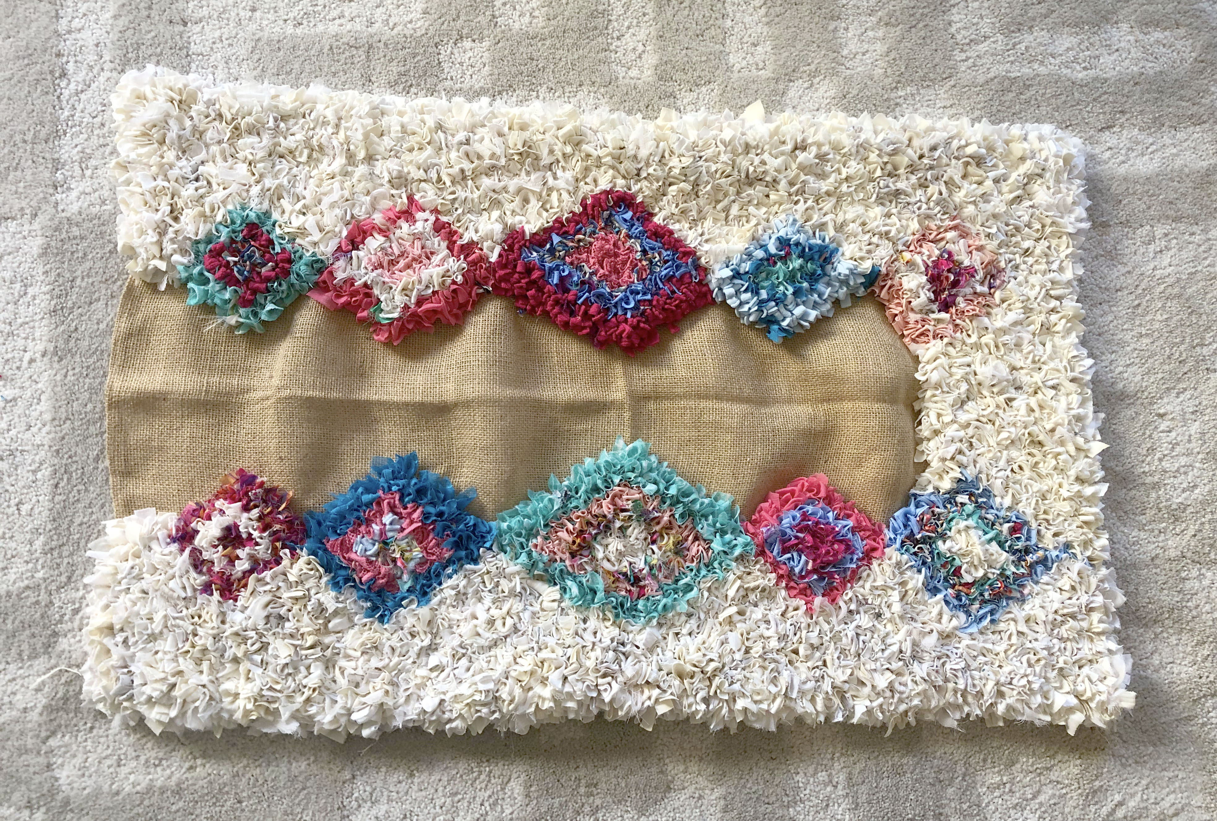 Nearly finished rag rug made on hessian or burlap using recycled materials