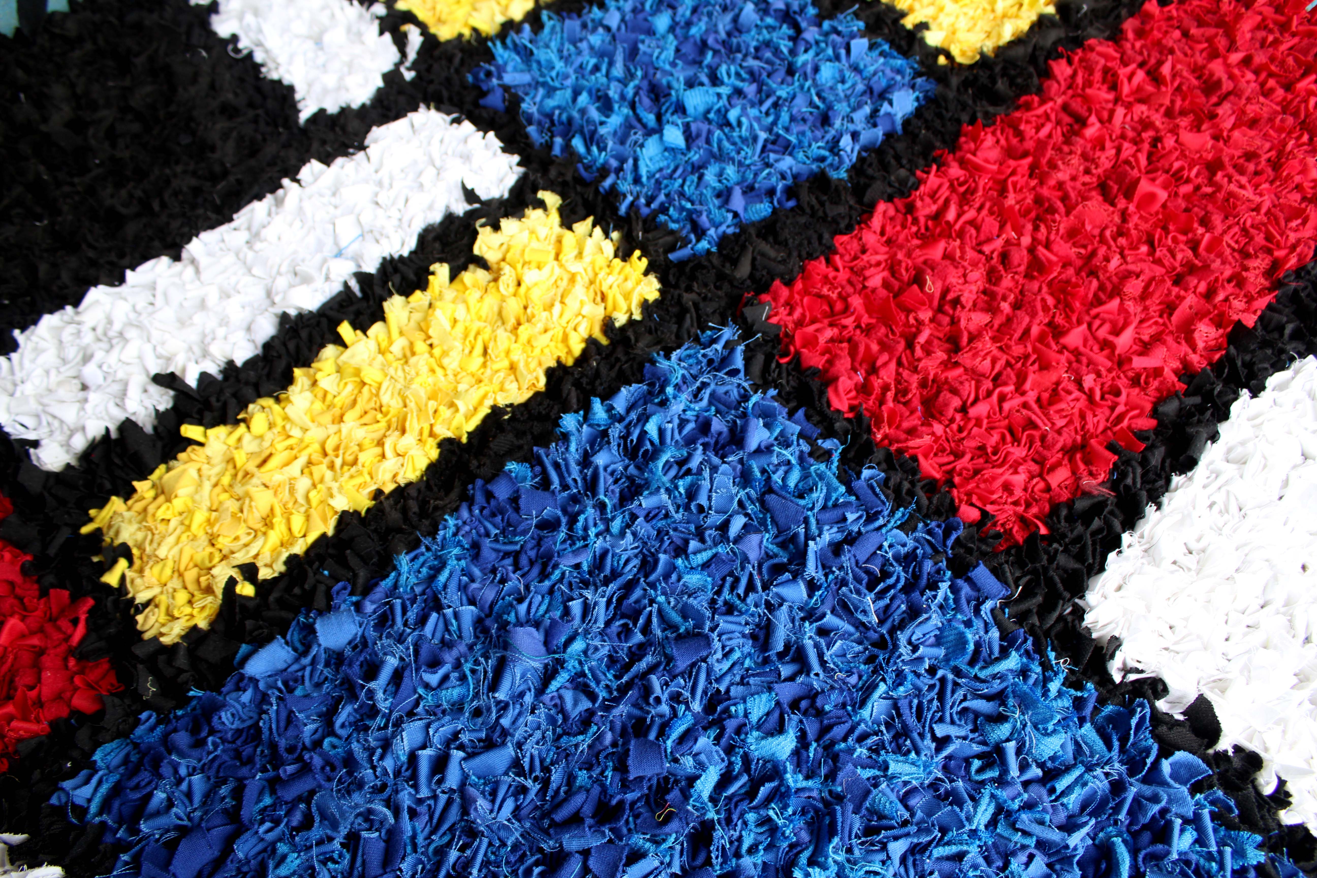 Mondrian inspired rag rug up close details of the blue fabrics