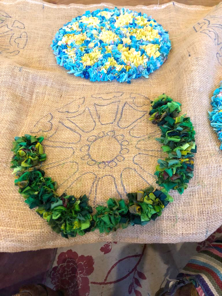Green rag rug with design sketched onto the hemmed hessian