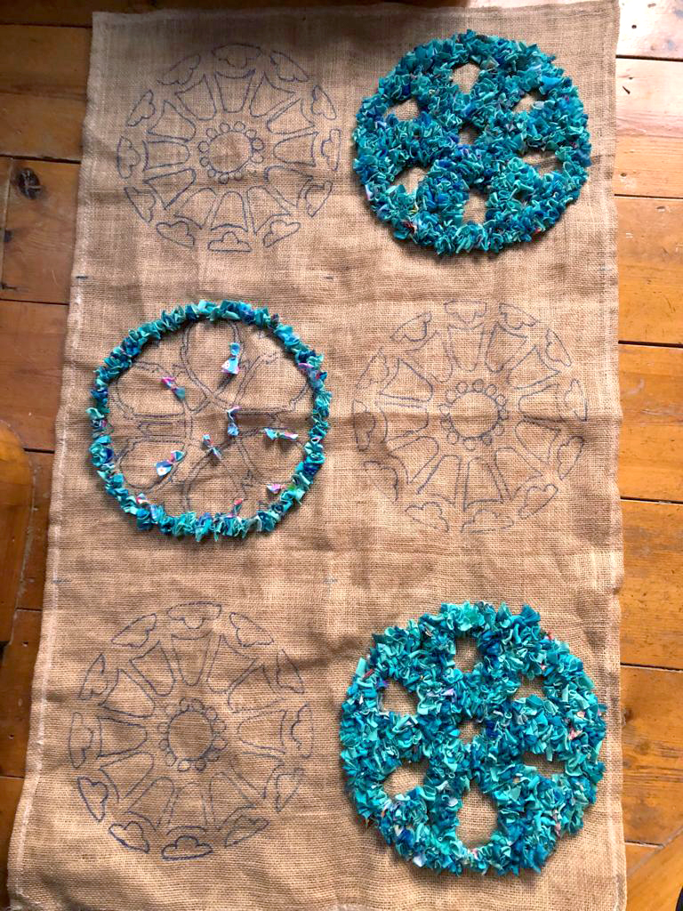 Sketching a design onto hessian to make a handmade rag rug