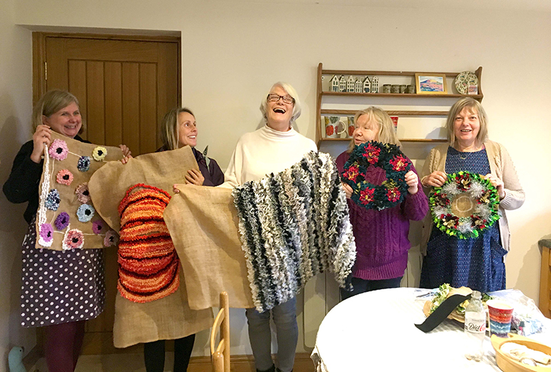 Craft lovers holding up their rag rug creations at the Hertfordshire Ragged Life Rag Rug Coffee
