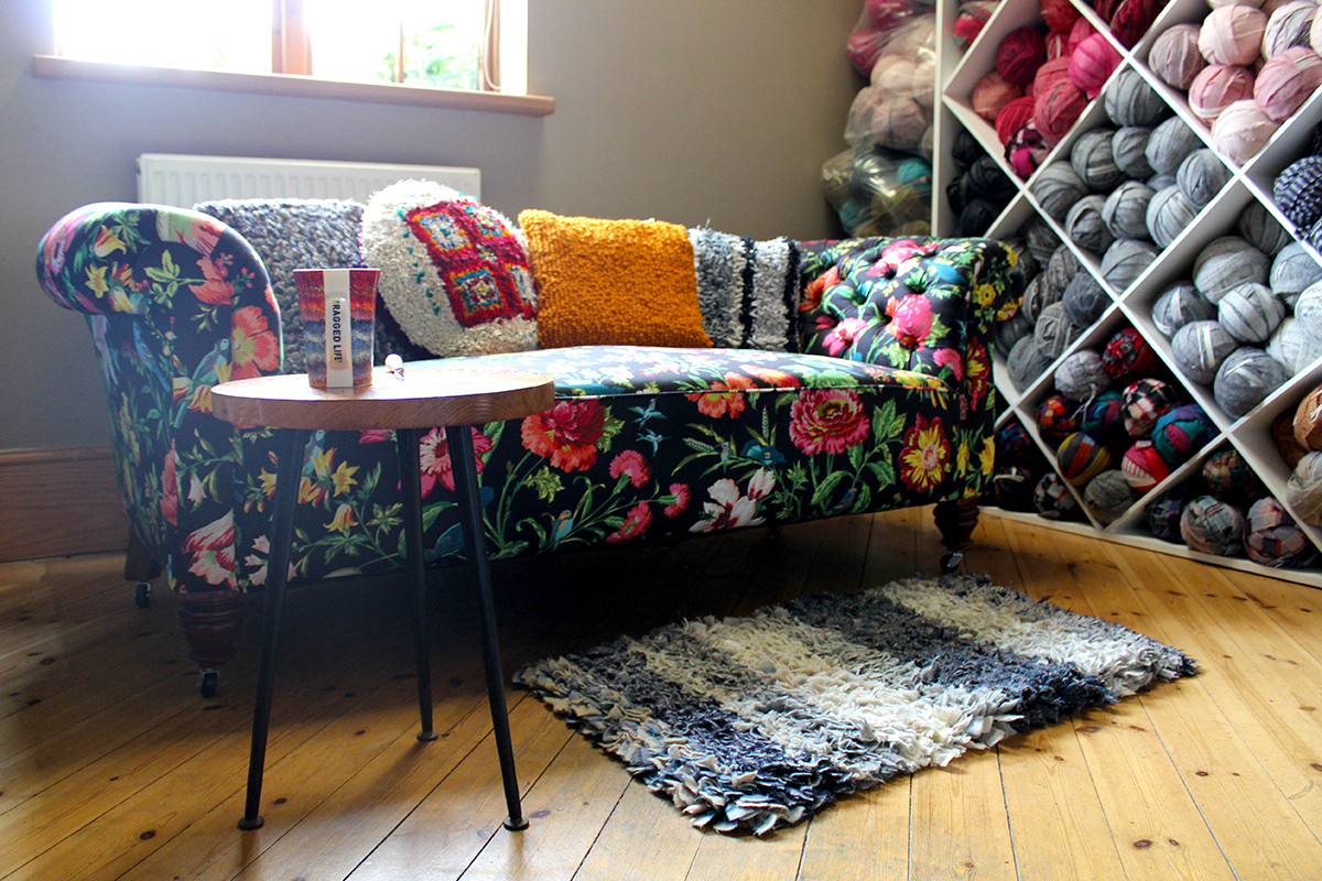 Statement floral sofa with rag rug cushions