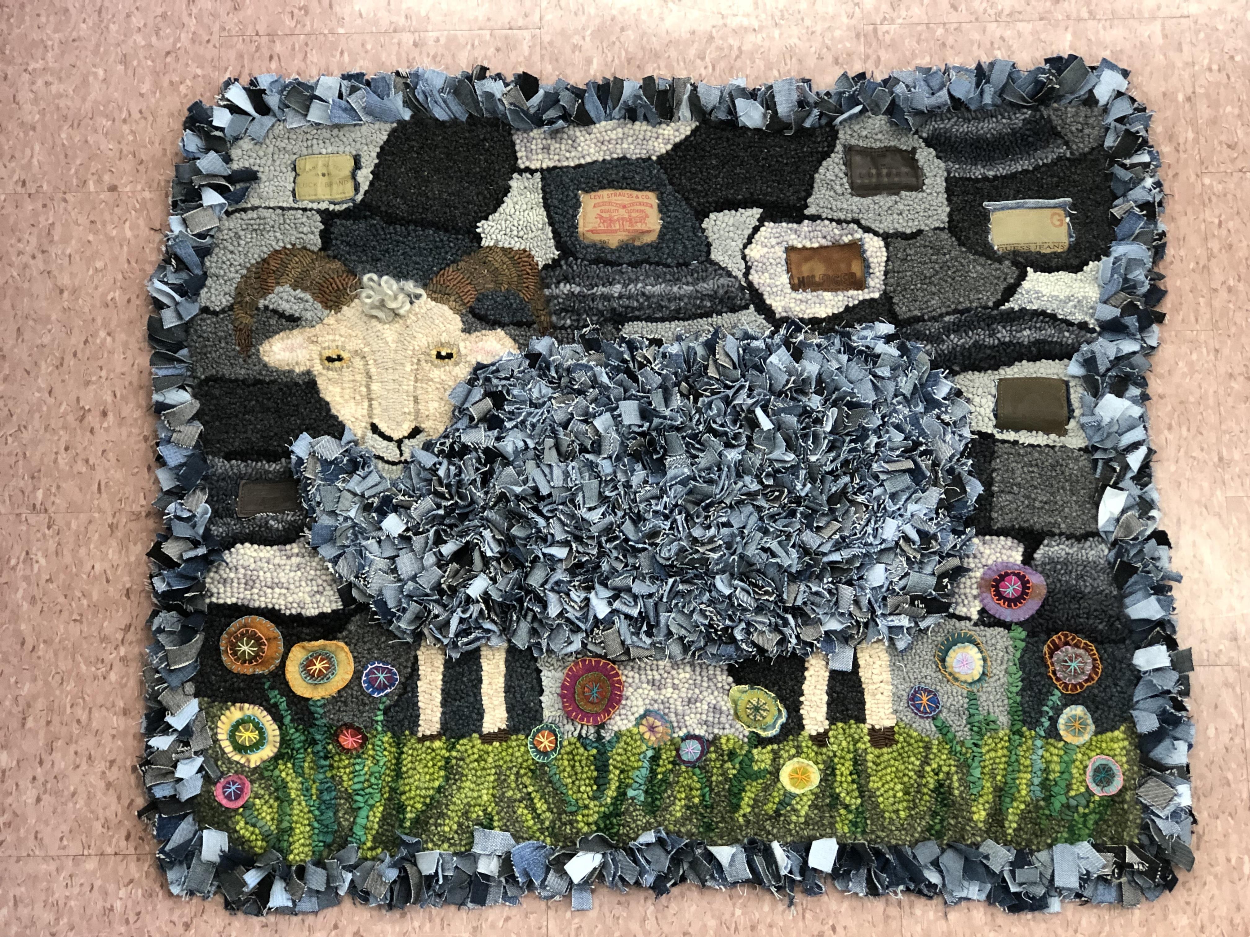 A hooked textile artwork of a sheep made with denim scraps by Yvonne Iten-Scott