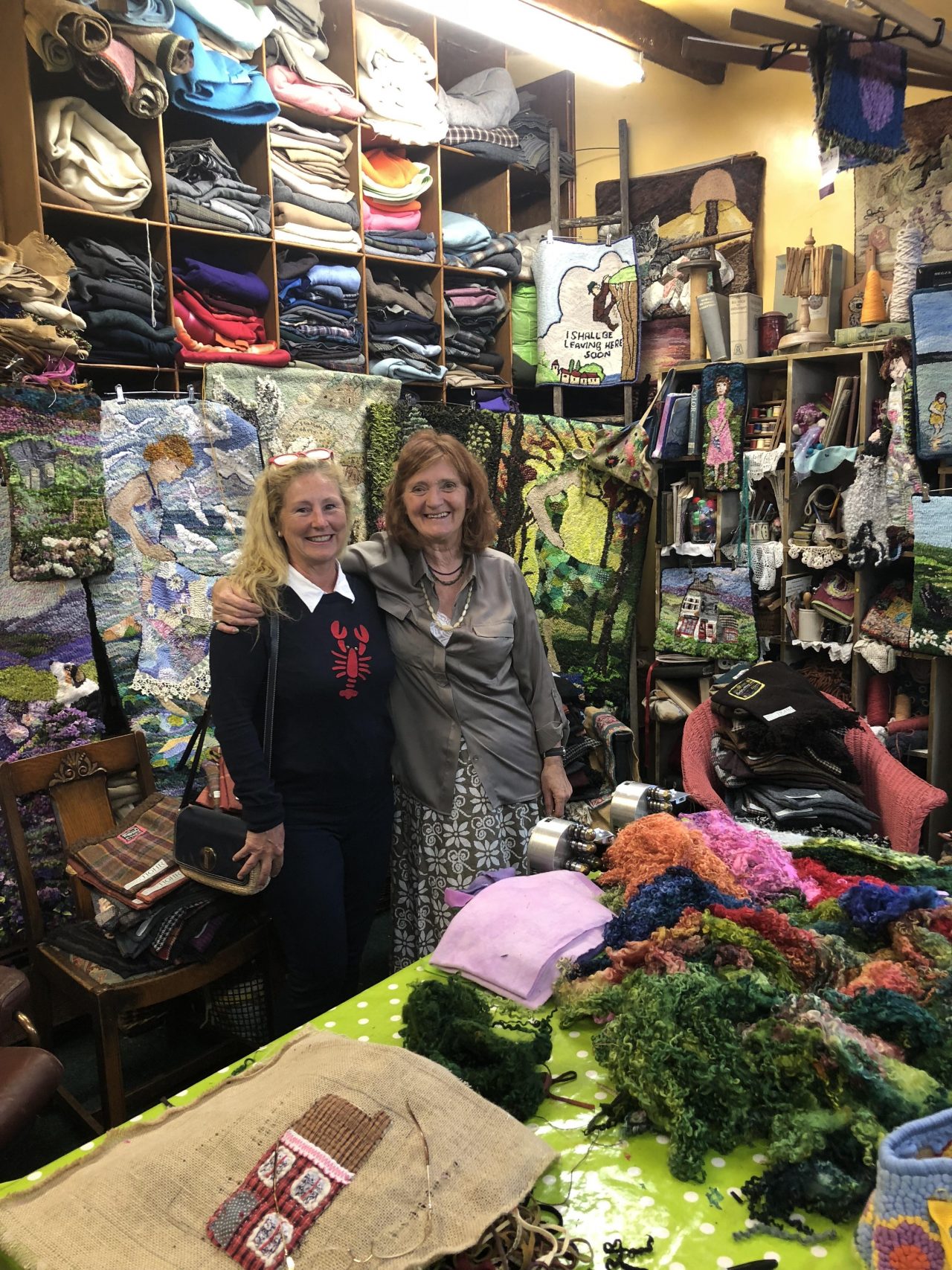 Yvonne Iten-Scott with rug maker Heather Ritchie in Heathers studio packed with fabrics.