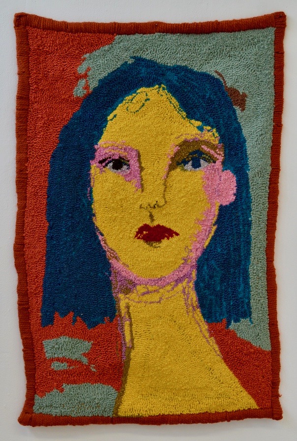 Textile art portrait featuring a woman with yellow skin and blue hair by Selby Hurst Inglefield
