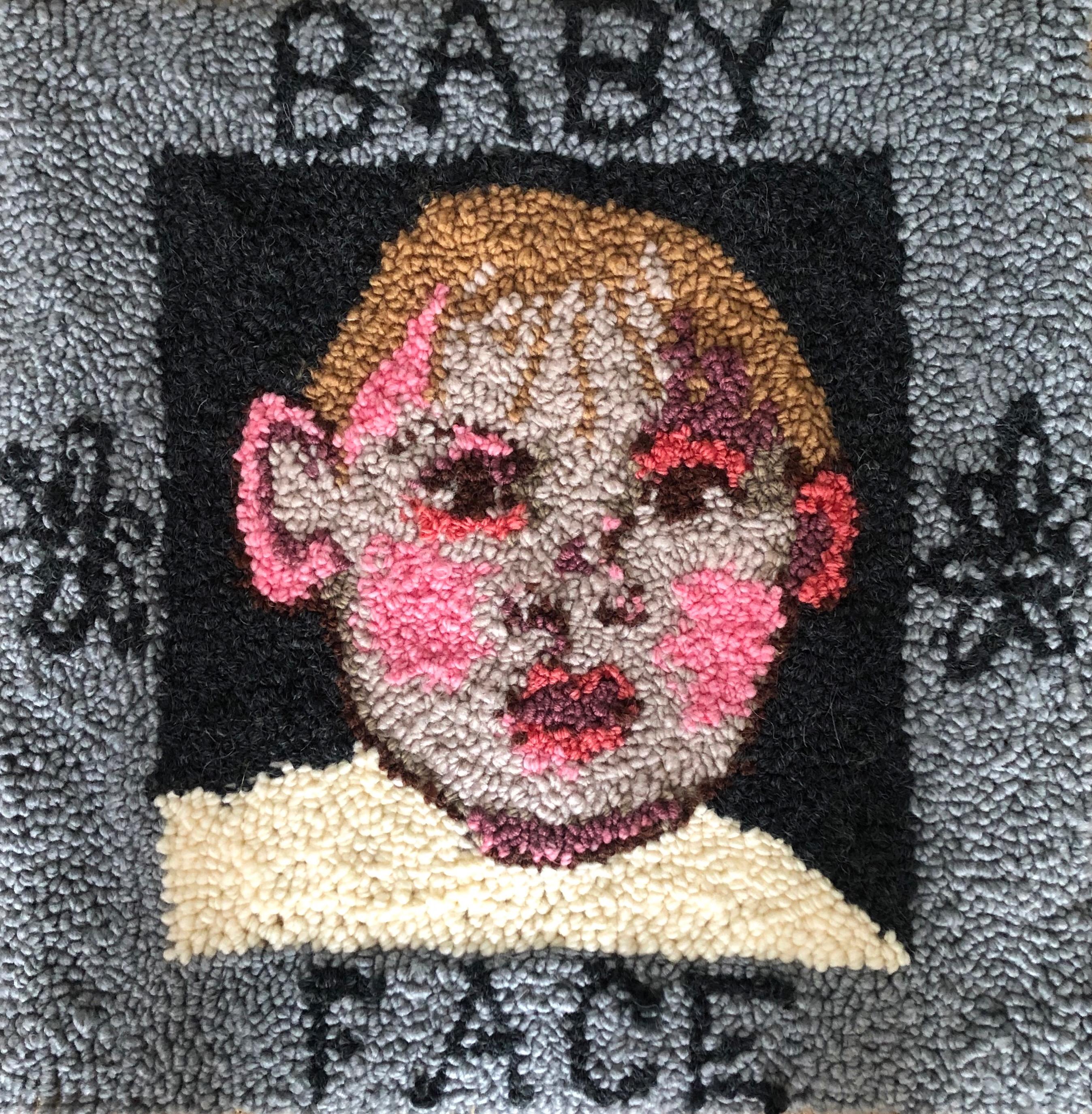 textile art of a small male childs face with words 'baby face' by Selby Hurst Inglefield