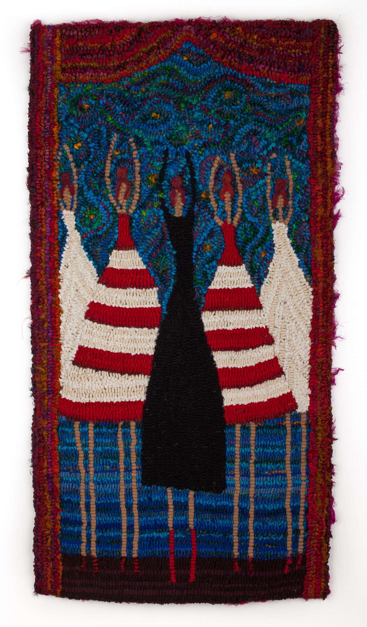 A rug hooked piece of art featuring 5 female figures, 1 in the middle with in a black dress, 2 in red and white stripes and 2 in white with a blue background and red edging by Laura Kenney.