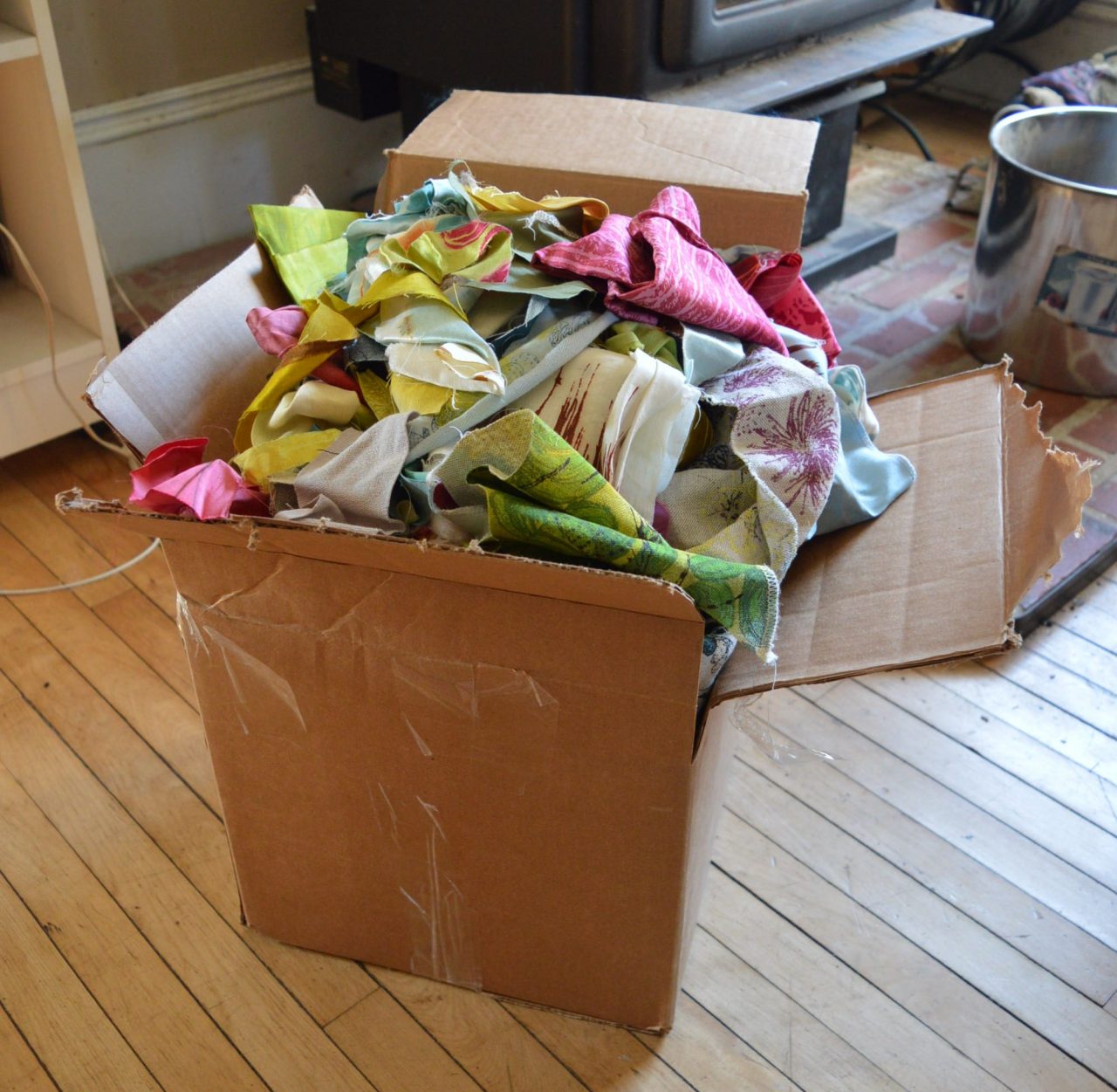 a cardboard box full of material scraps.