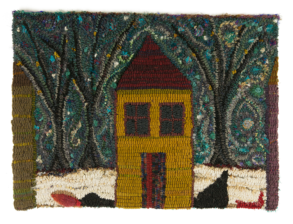 Textile art of a yellow house against a backdrop of blue and grey trees by Laura Kenney