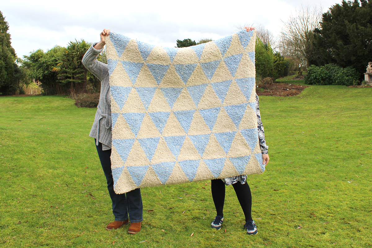 Simple rag rug made using cream and blue wool blanket yarn