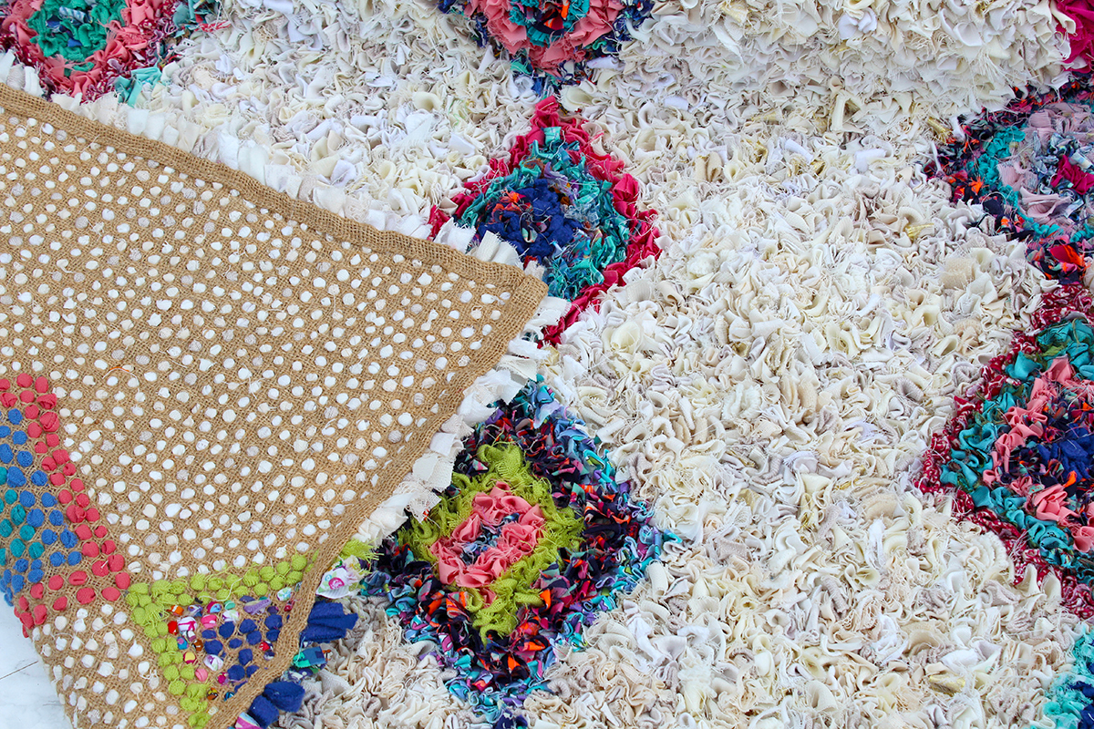 The back of a Moroccan style berber rag rug on hessian