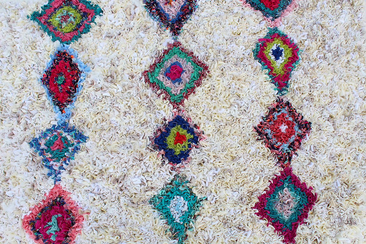 Diamond design rag rug in multicoloured old clothing and cream