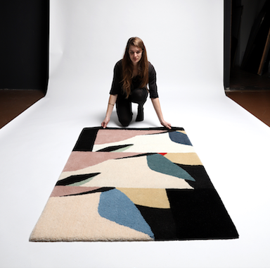 Abigail Wheeler Laying Rectangle Rug White Backdrop