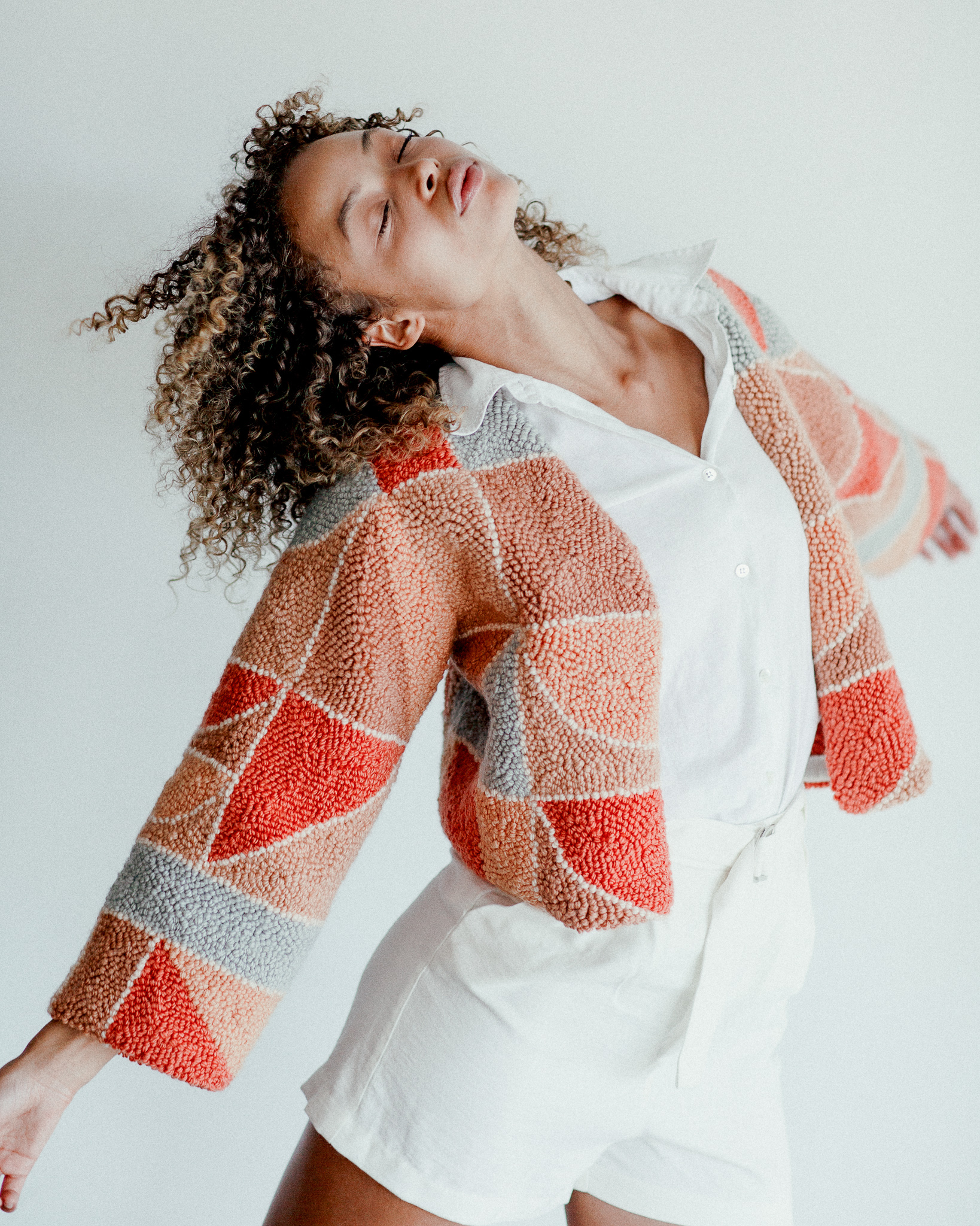 Micah Clasper- Torch Needle Punched Jacket Modelled Action Shot Pink Grey Beige