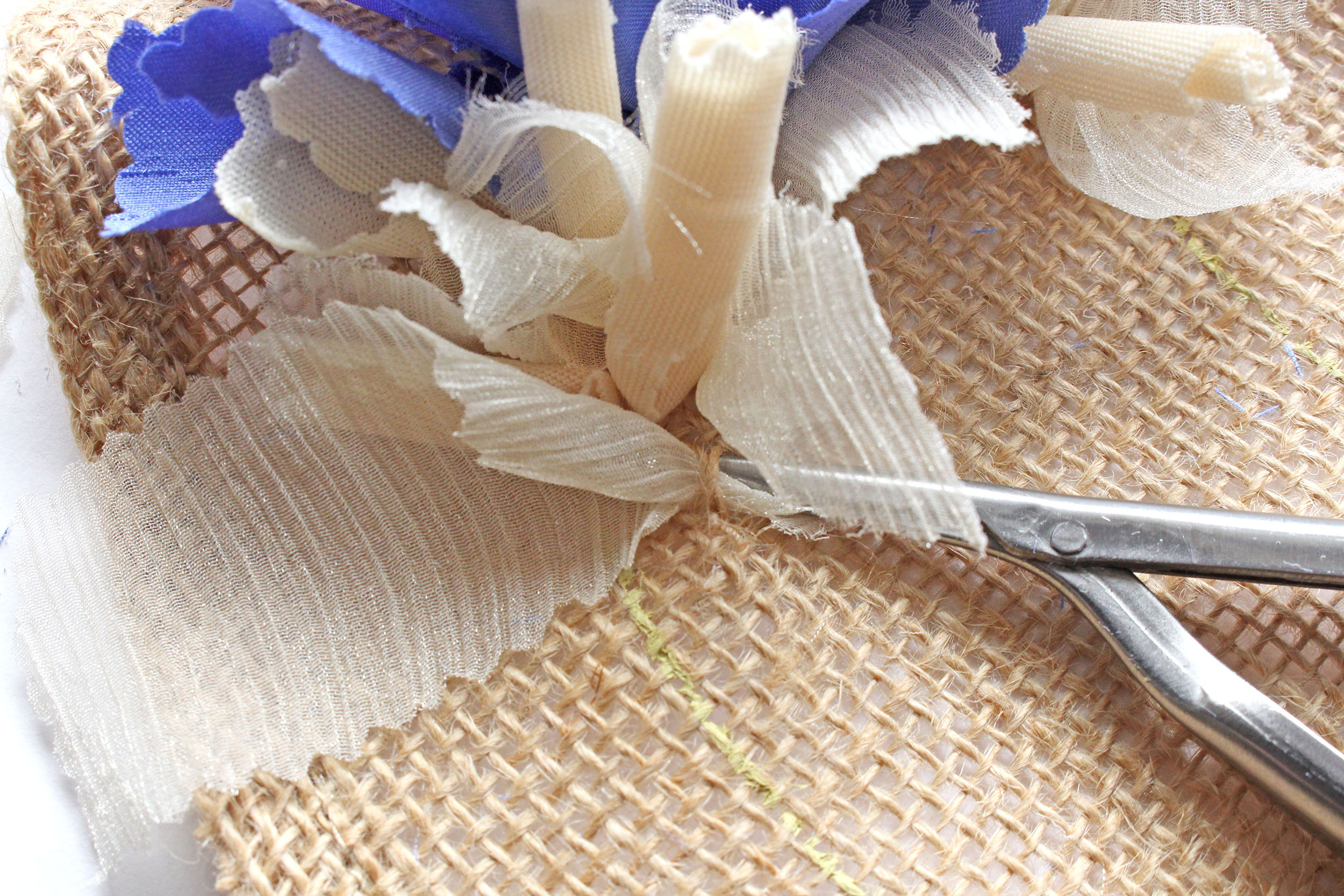 Pulling Cream Fabric Through Hessian With Spring Tool