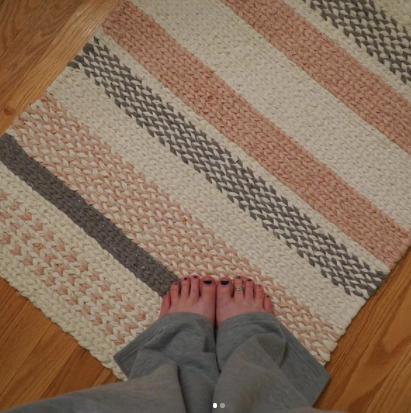 pink white and black twined patterned rag rug