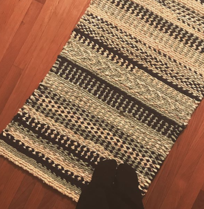 Striped patterned turquoise white and black twined rug