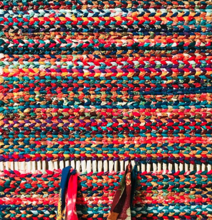 multicoloured patterned twined rag rug